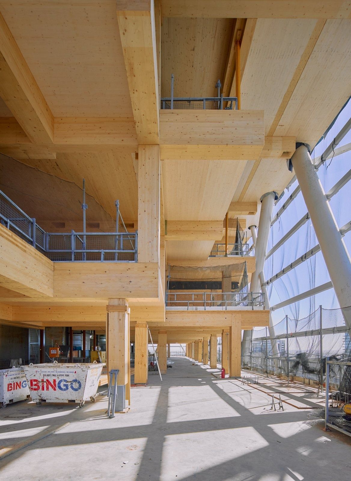 Atlassian: Exposed timber beams and columns on a lower floor