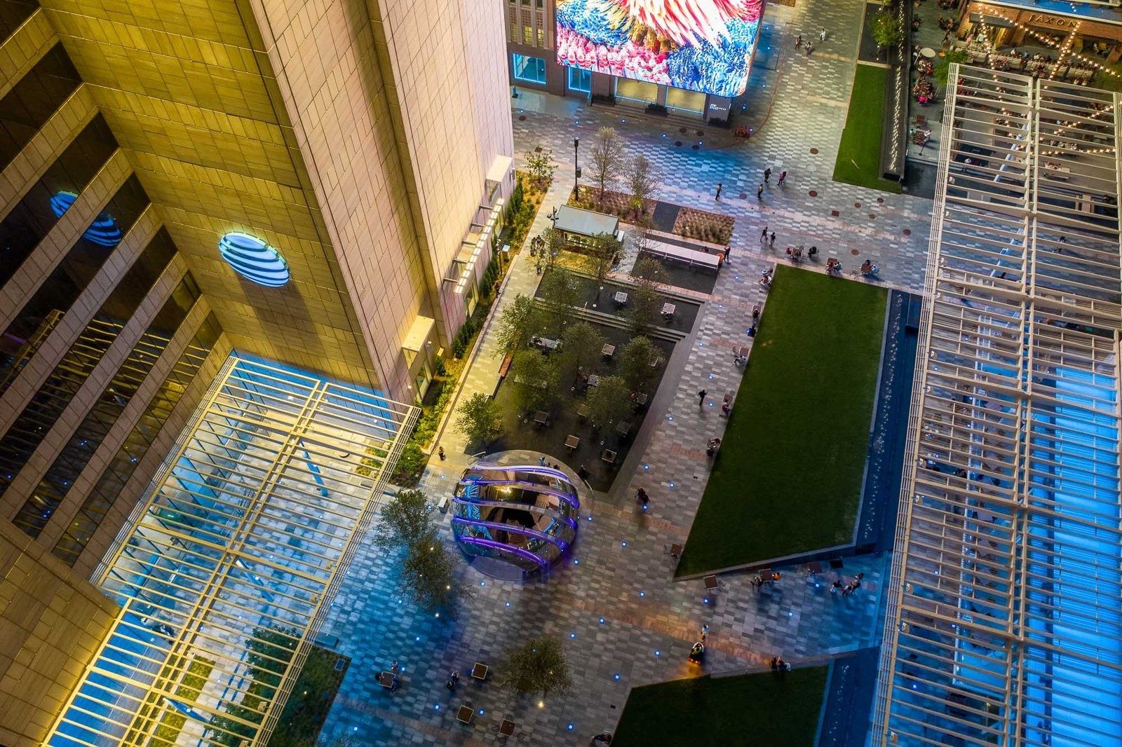 AT&T: Aerial view of a plaza with lawns, a canopy and a video wall