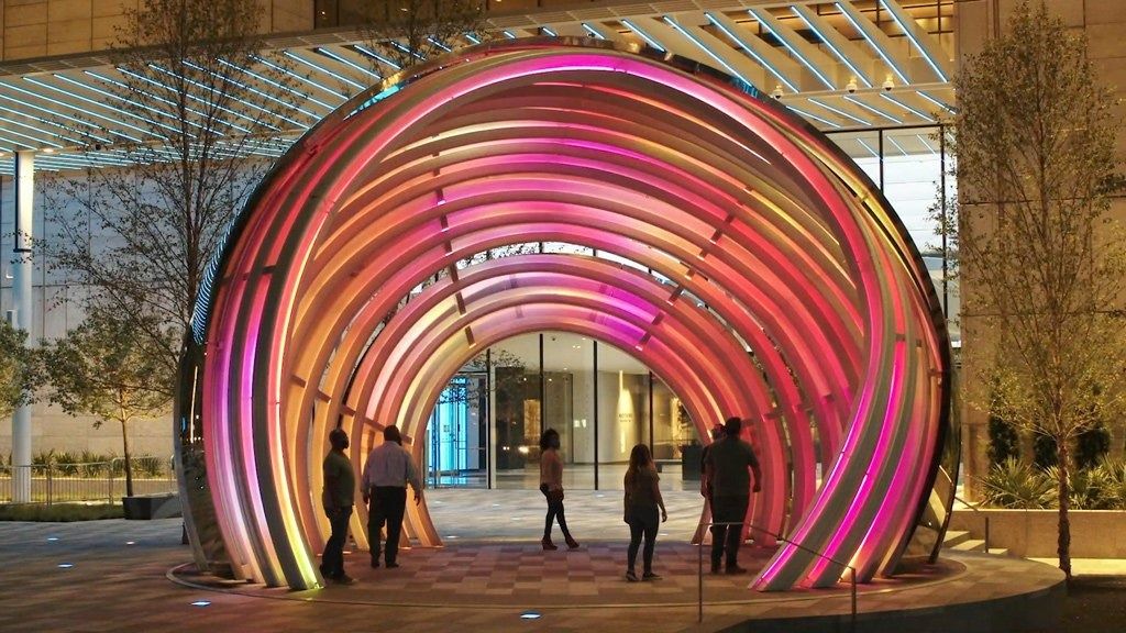 AT&T: Pink and orange tunnel sculpture on a plaza