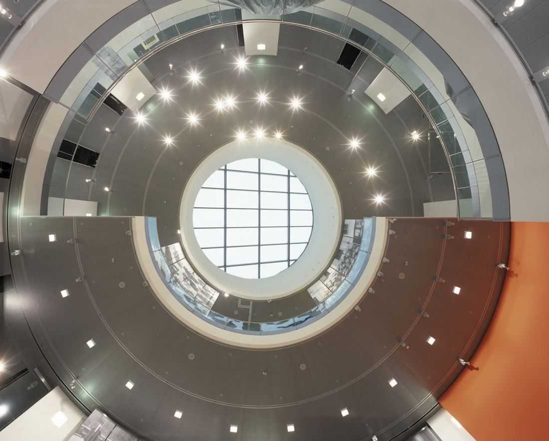 Audi: View up through a circular atrium with ring-shaped floors and a round skylight