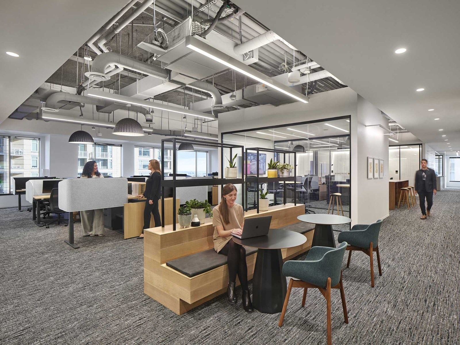 AvalonBay Communities: Desks and booths under an open ceiling
