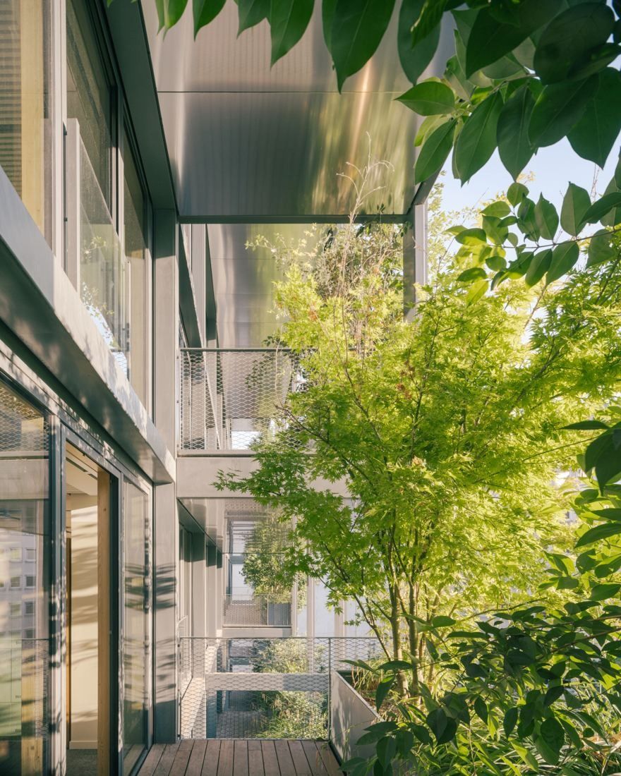 AXA: Narrow balcony with trees and planting between glass façades