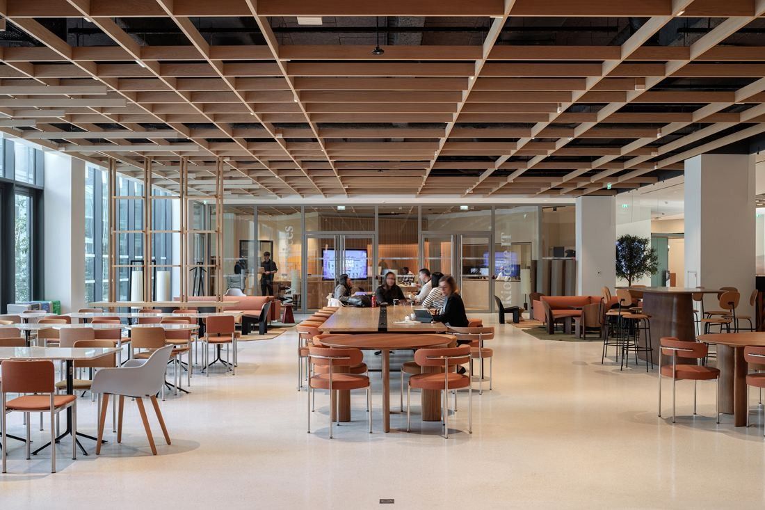 AXA: Restaurant with wooden tables and terracotta chairs under a wooden lattice ceiling