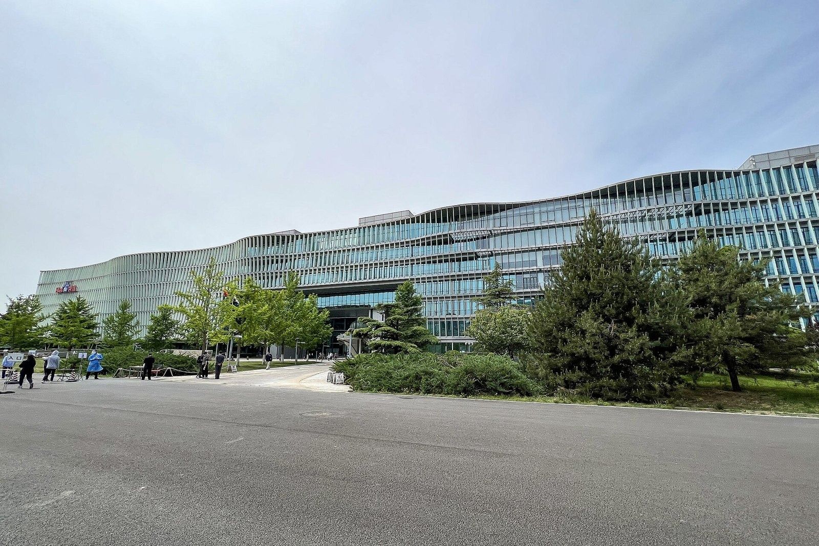 Baidu: Glass façade with horizontal louvres behind pine trees