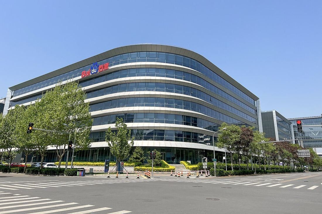 Curved glass building of Baidu Technology Park at a street corner