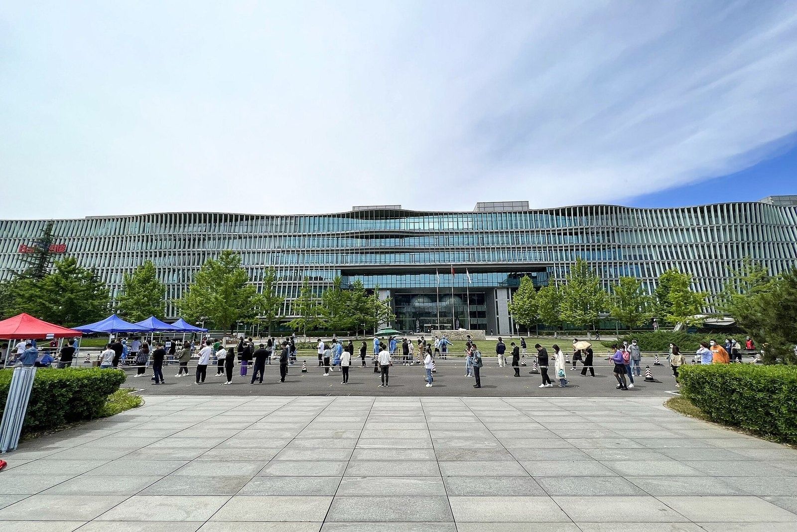 Baidu: Paved forecourt in front of a long glass building