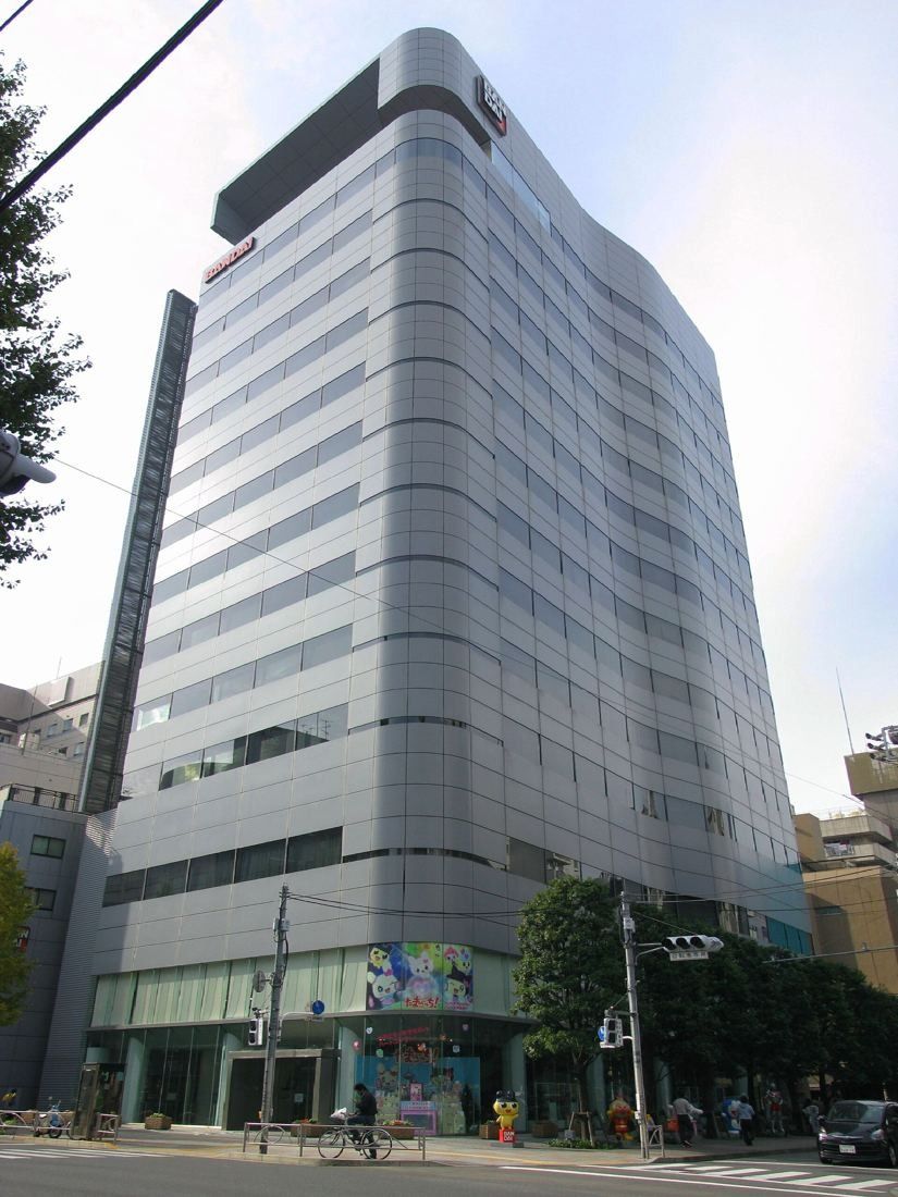 Grey and glass office tower on a street corner