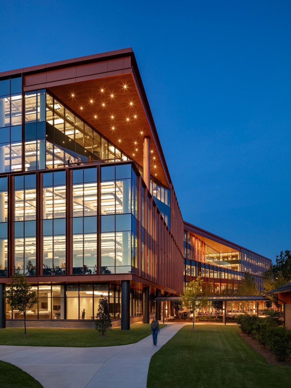 A brick and glass building at dusk