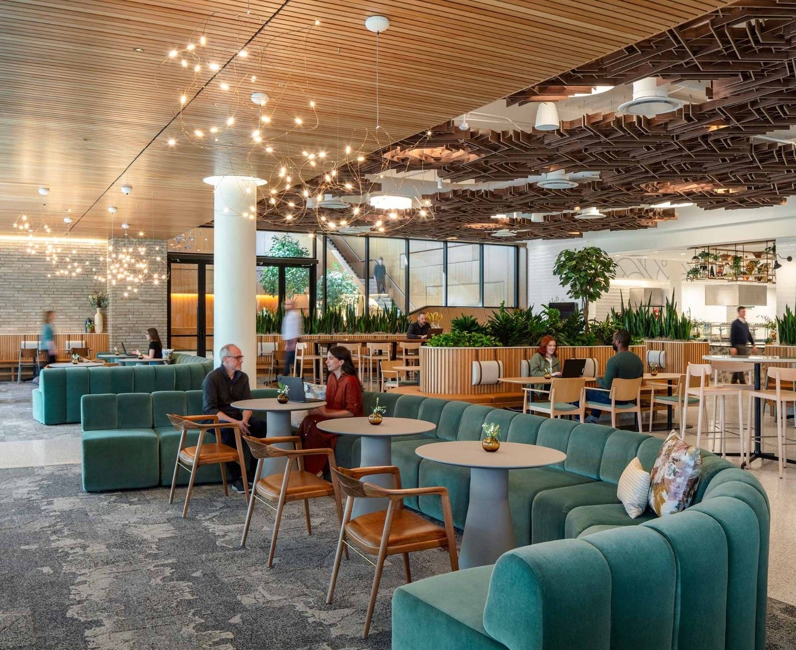 A café with teal booths and hanging lights