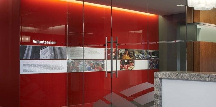 Bank of America: Reception with a red glass wall and volunteer display