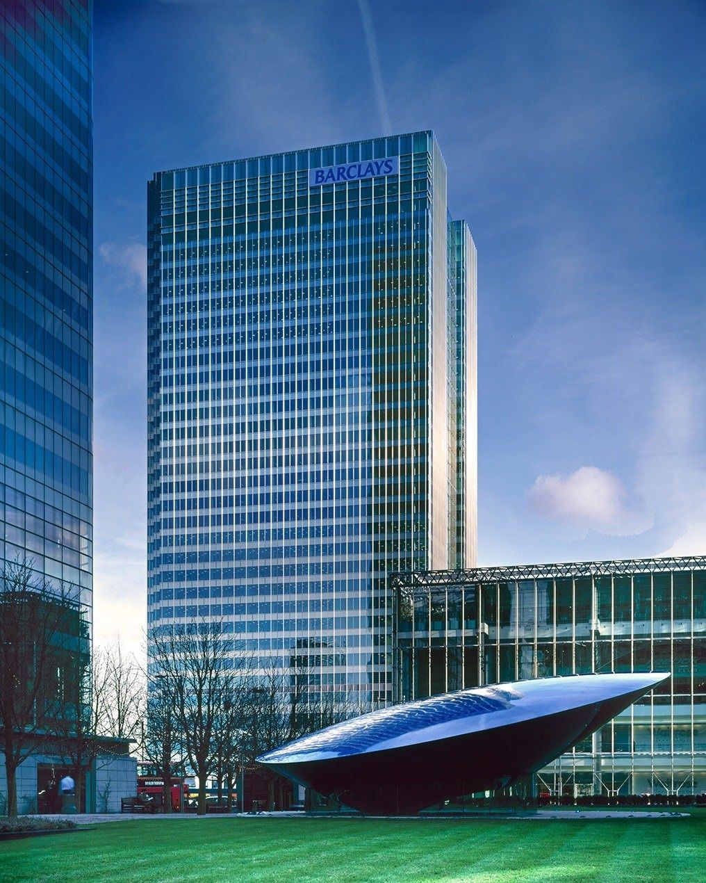 Barclays: Glass office tower with a red curved sculpture on the lawn in front