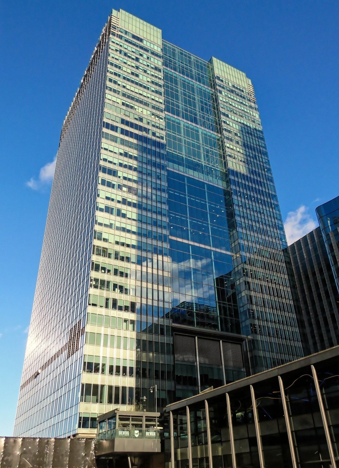 Barclays: Glass tower with a stepped facade under blue sky