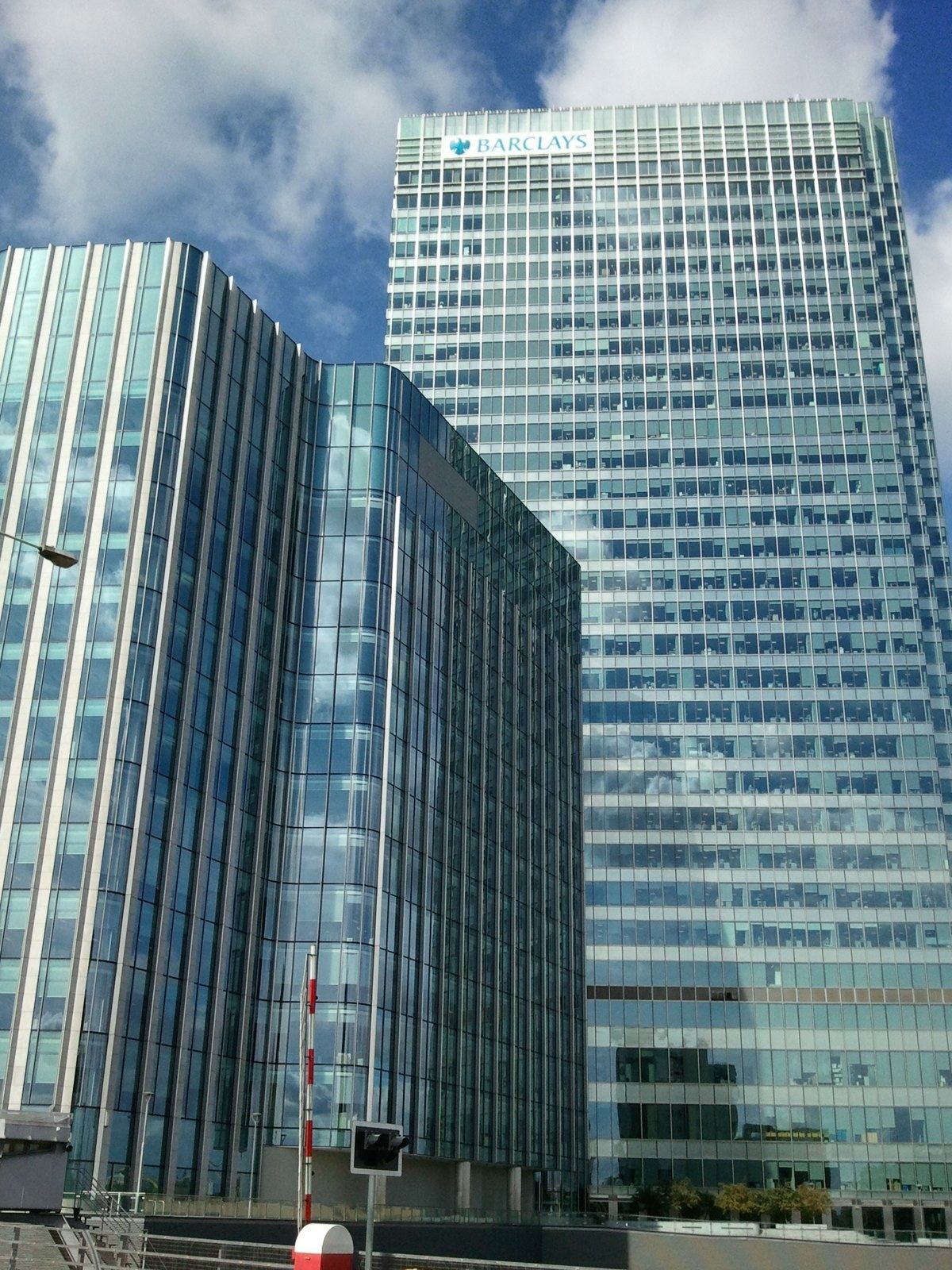 Barclays: Glass towers seen from below with a logo at the top