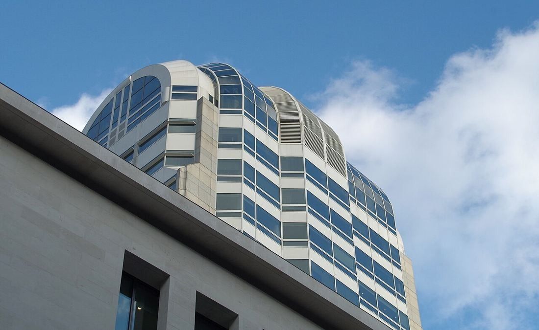 Upper floors and rounded top of 54 Lombard Street against the sky