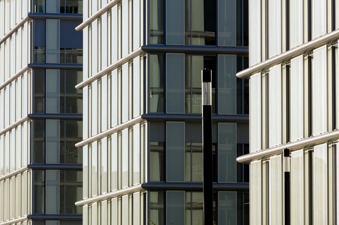 Close-up of white vertical fins on a glass facade