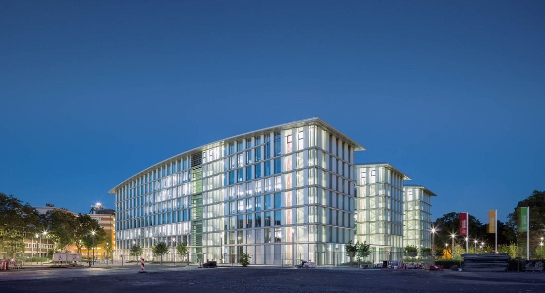 Glass office building lit up at night