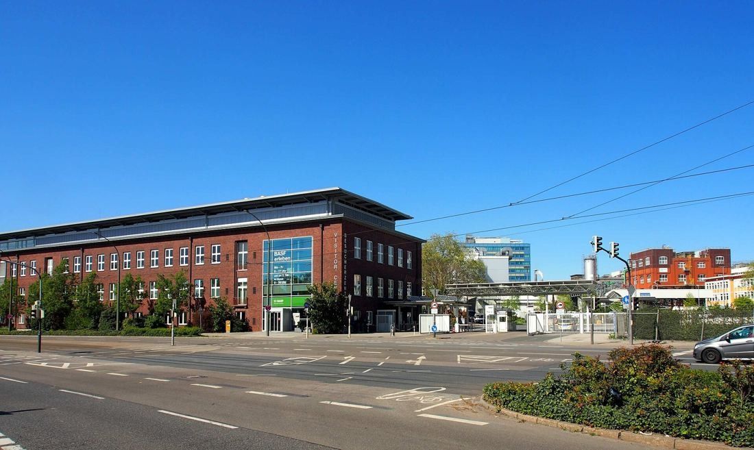 Red-brick building with a modern glass entrance on a street corner