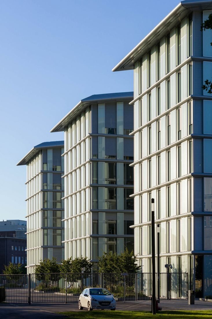 Tall glass blocks stepping back along a street