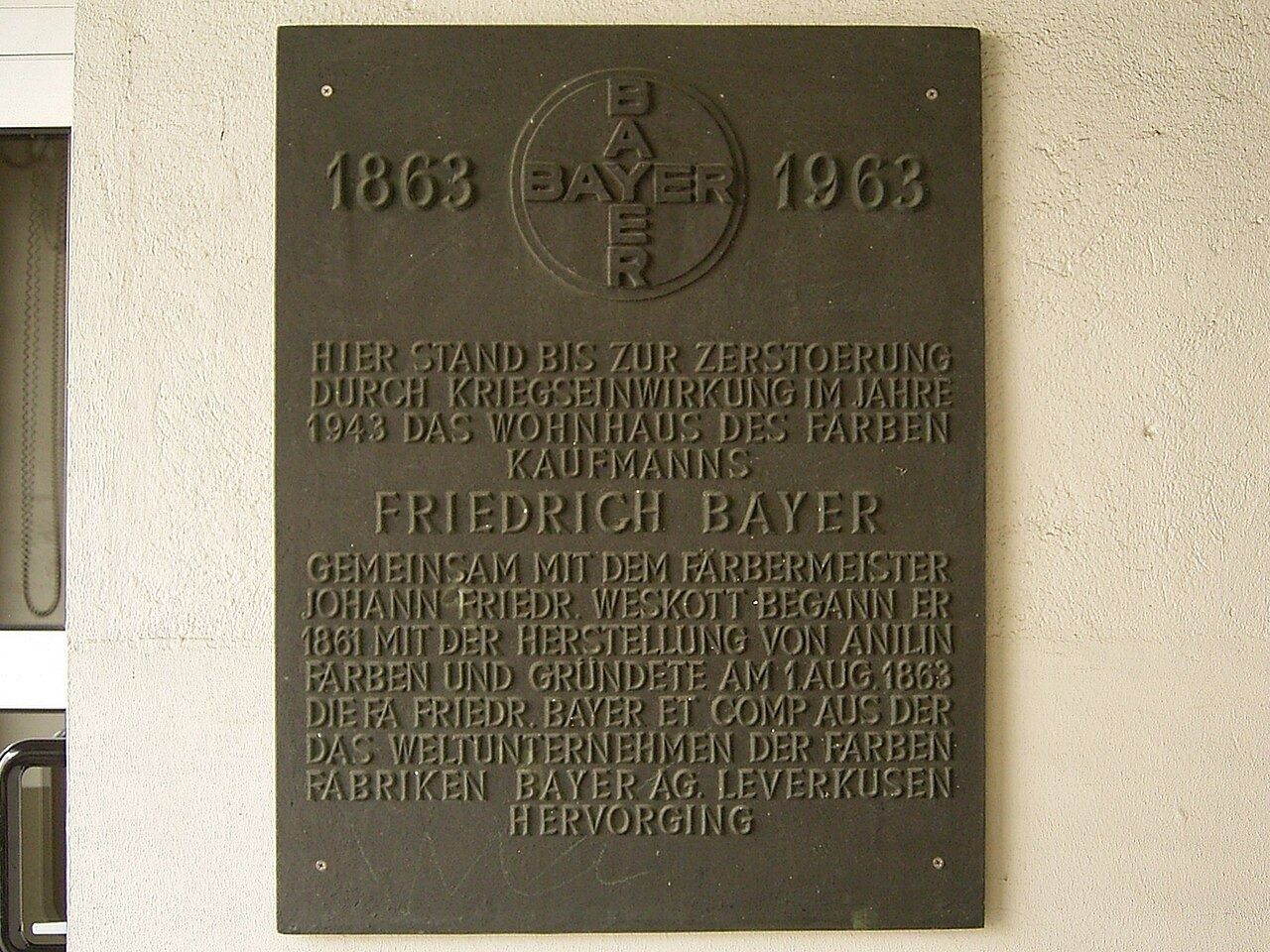 Bronze plaque with the Bayer cross and the years 1863 and 1963