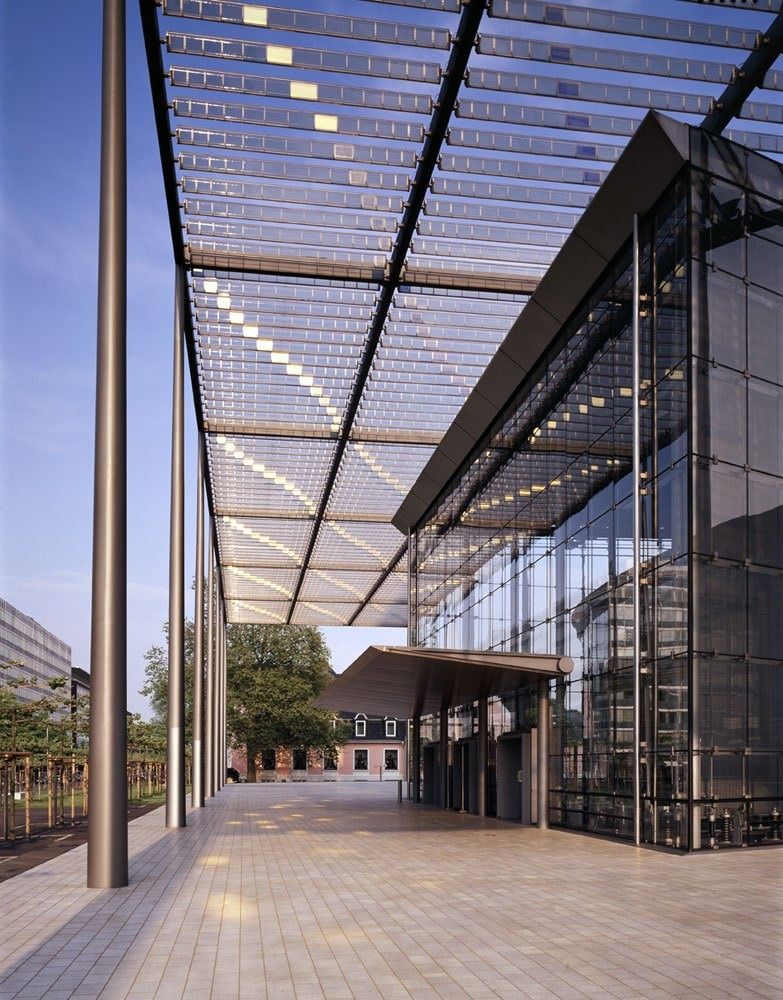 Bayer: Long glass pergola beside the building