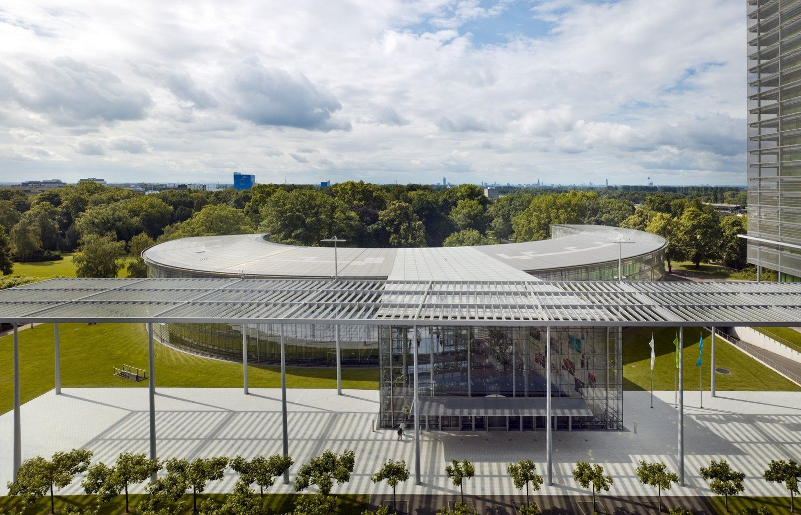Bayer: Low glass building beyond a park