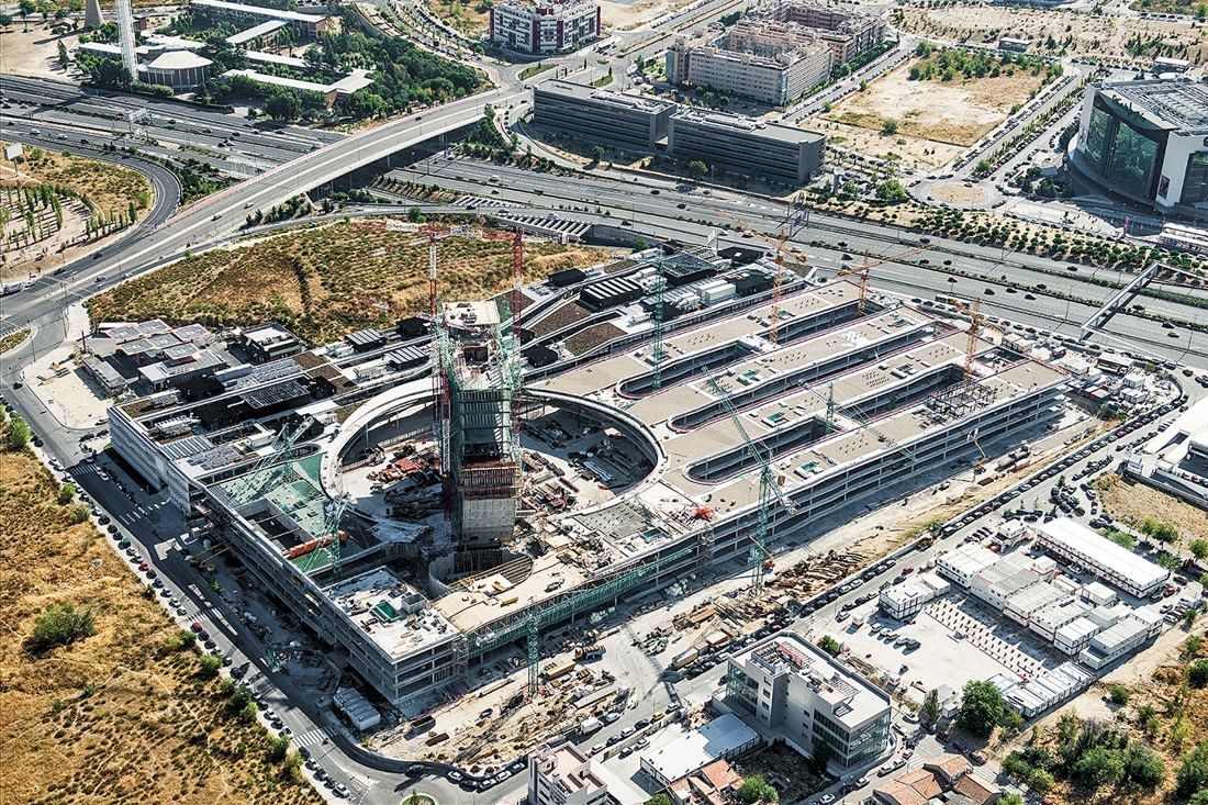 BBVA: Aerial view of the construction site with the tower's oval core rising from the plaza