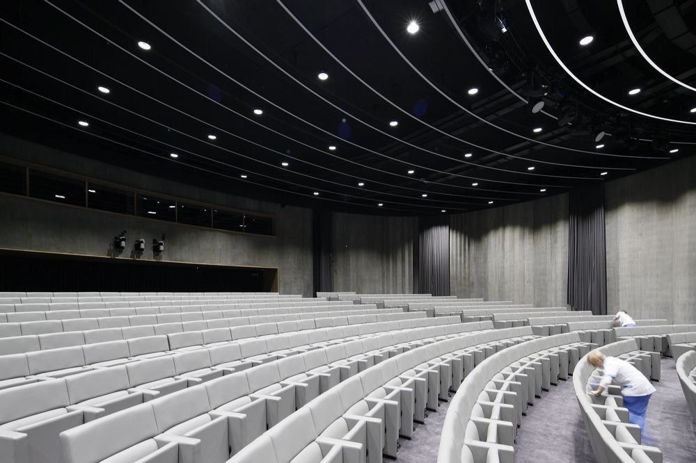 BBVA: Auditorium with curved rows of pale seats and a dark ceiling