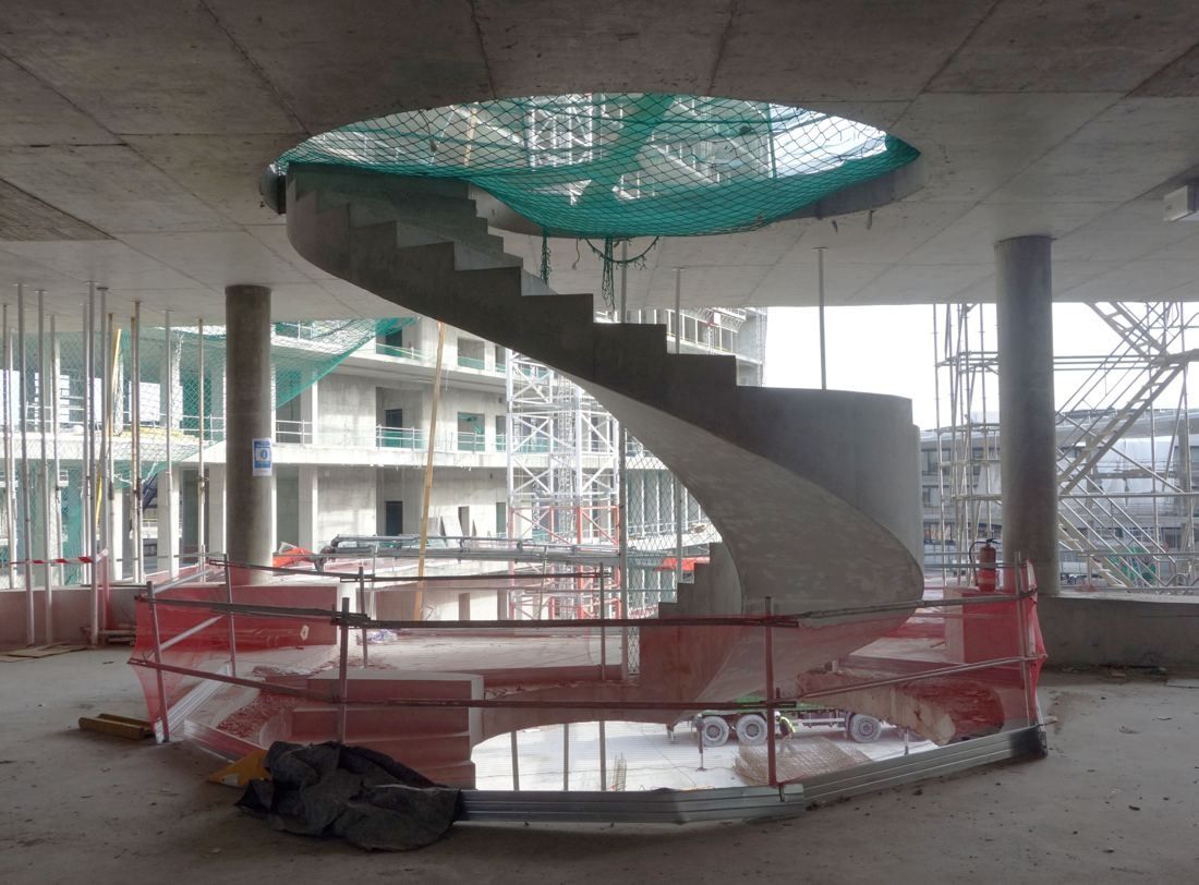 BBVA: Concrete spiral staircase under construction inside an unfinished building