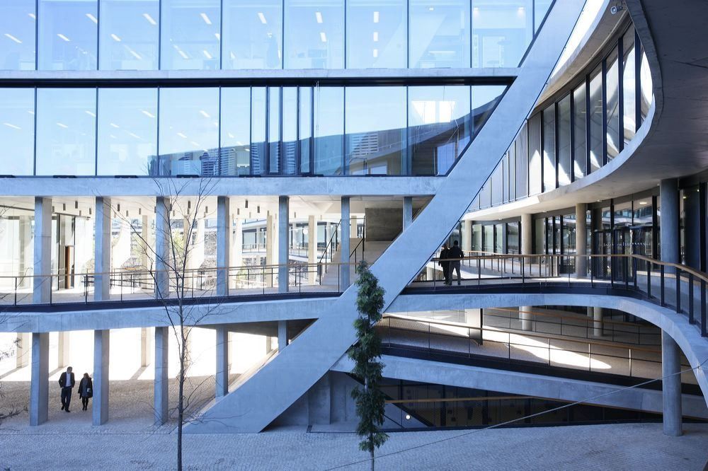 BBVA: Curving bridge and glazed walkways crossing a courtyard between office buildings