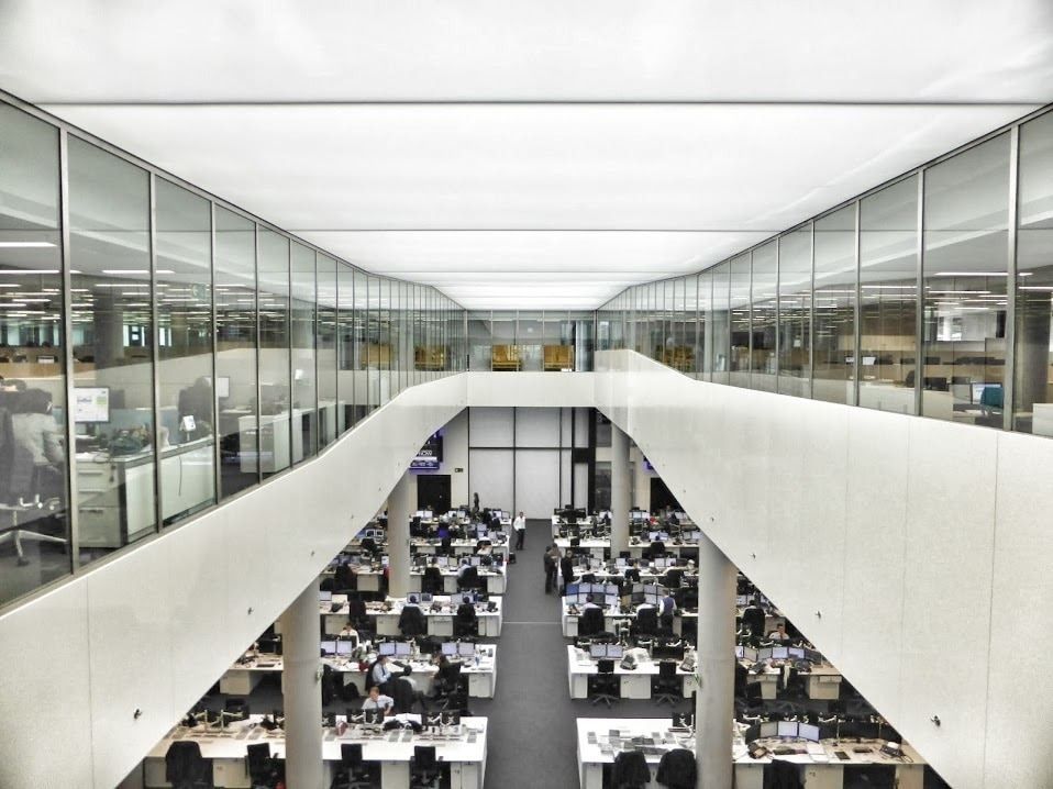 BBVA: Double-height office space seen from above between two glazed upper floors