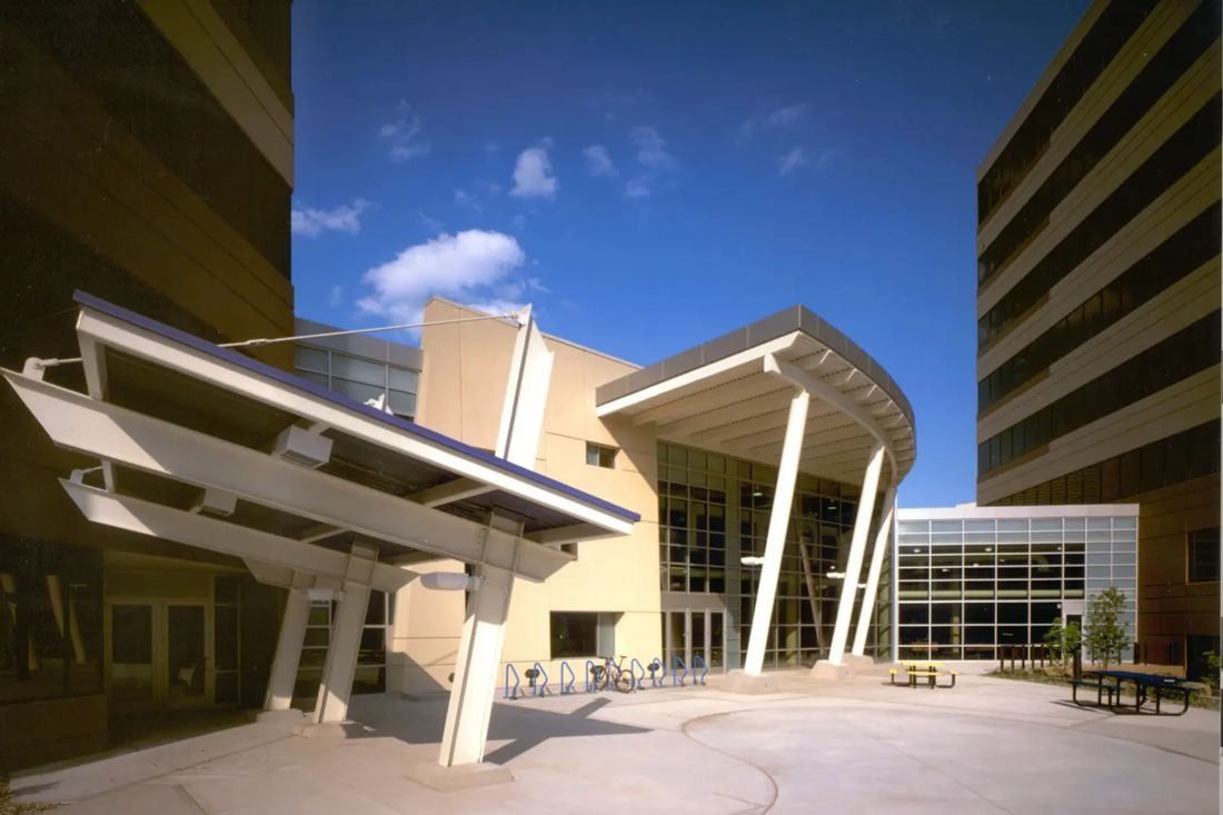 Best Buy: Courtyard with angled white canopies in front of a glass entrance between office towers