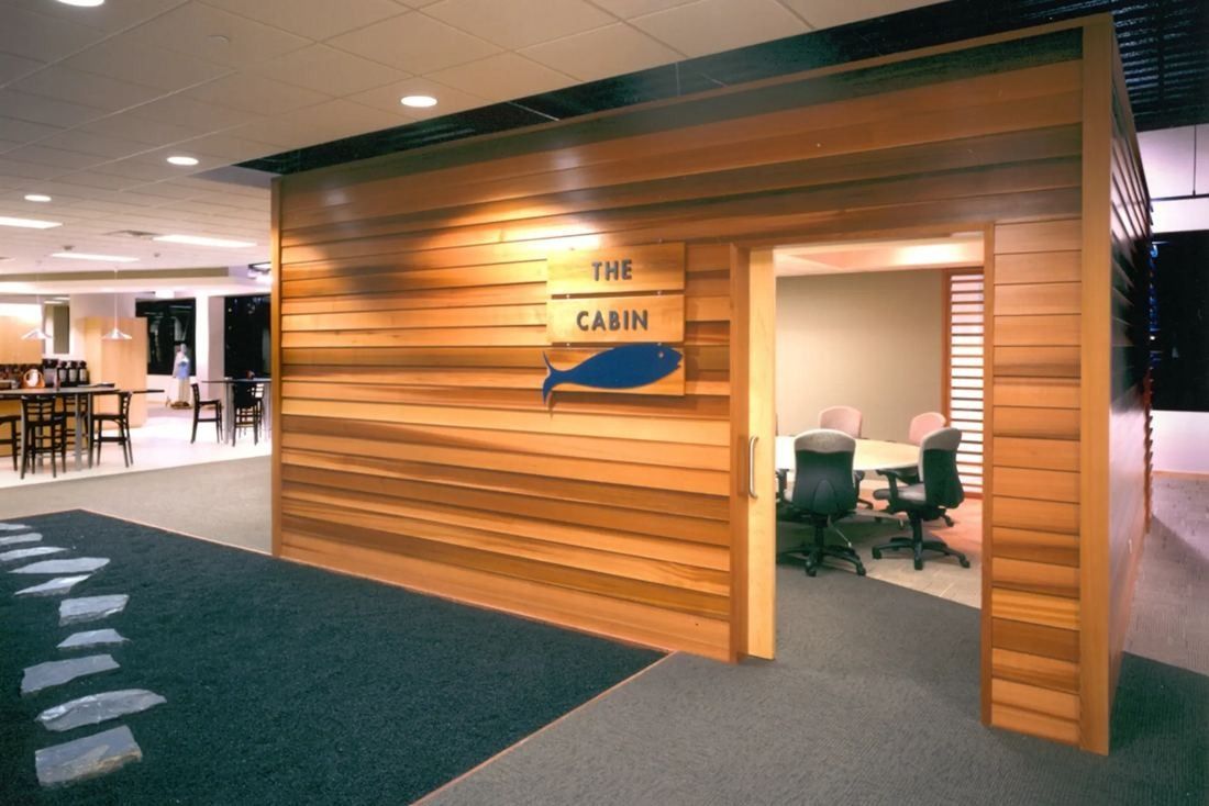 Best Buy: Wood-clad meeting room built as a small cabin inside an open office floor