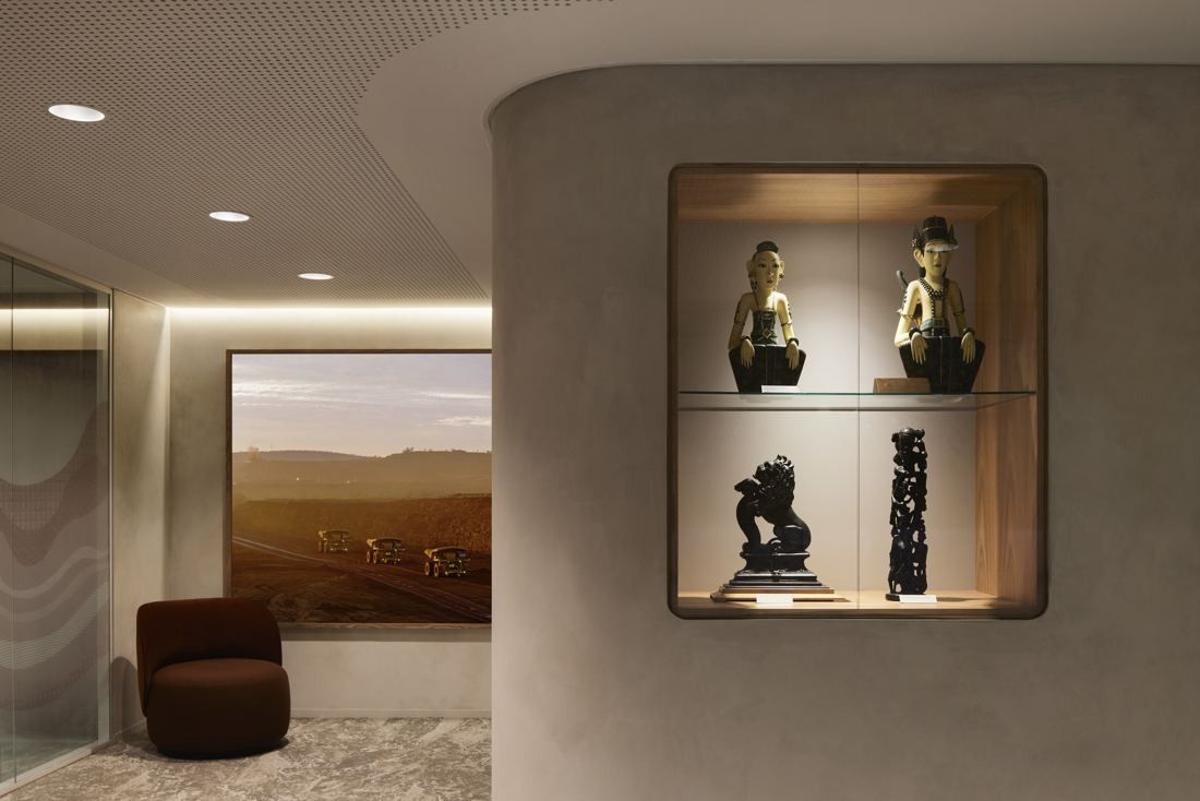 BHP: Curved plaster wall with a lit niche of sculptures and a landscape painting