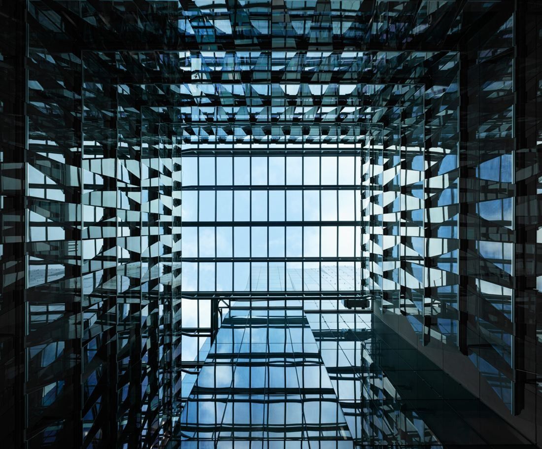BHP: Glass atrium seen from inside with reflections of the surrounding floors