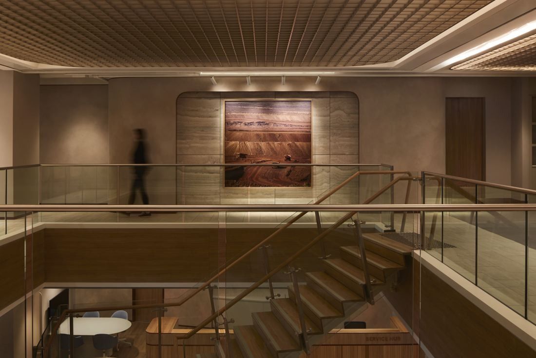 BHP: Timber staircase with glass balustrade linking two floors, a textured artwork on the wall beyond