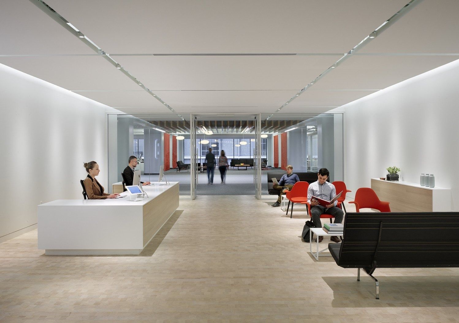 Block: A white reception desk at the end of a long hall