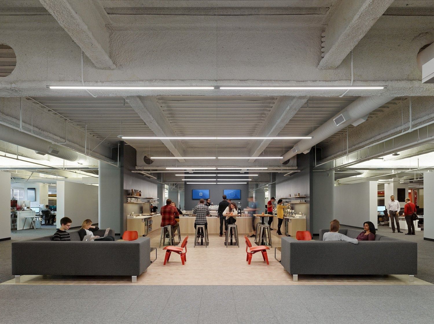 Block: Sofas and red stools in an open hall