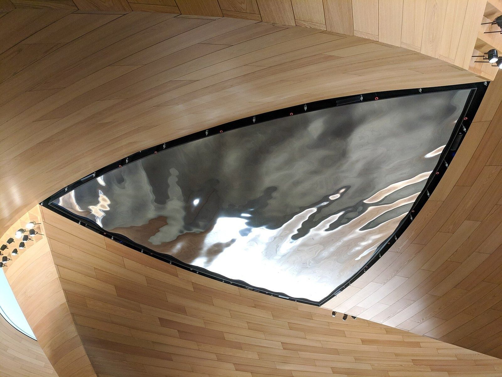 Bloomberg: A timber-lined lobby with a mirrored ceiling sculpture