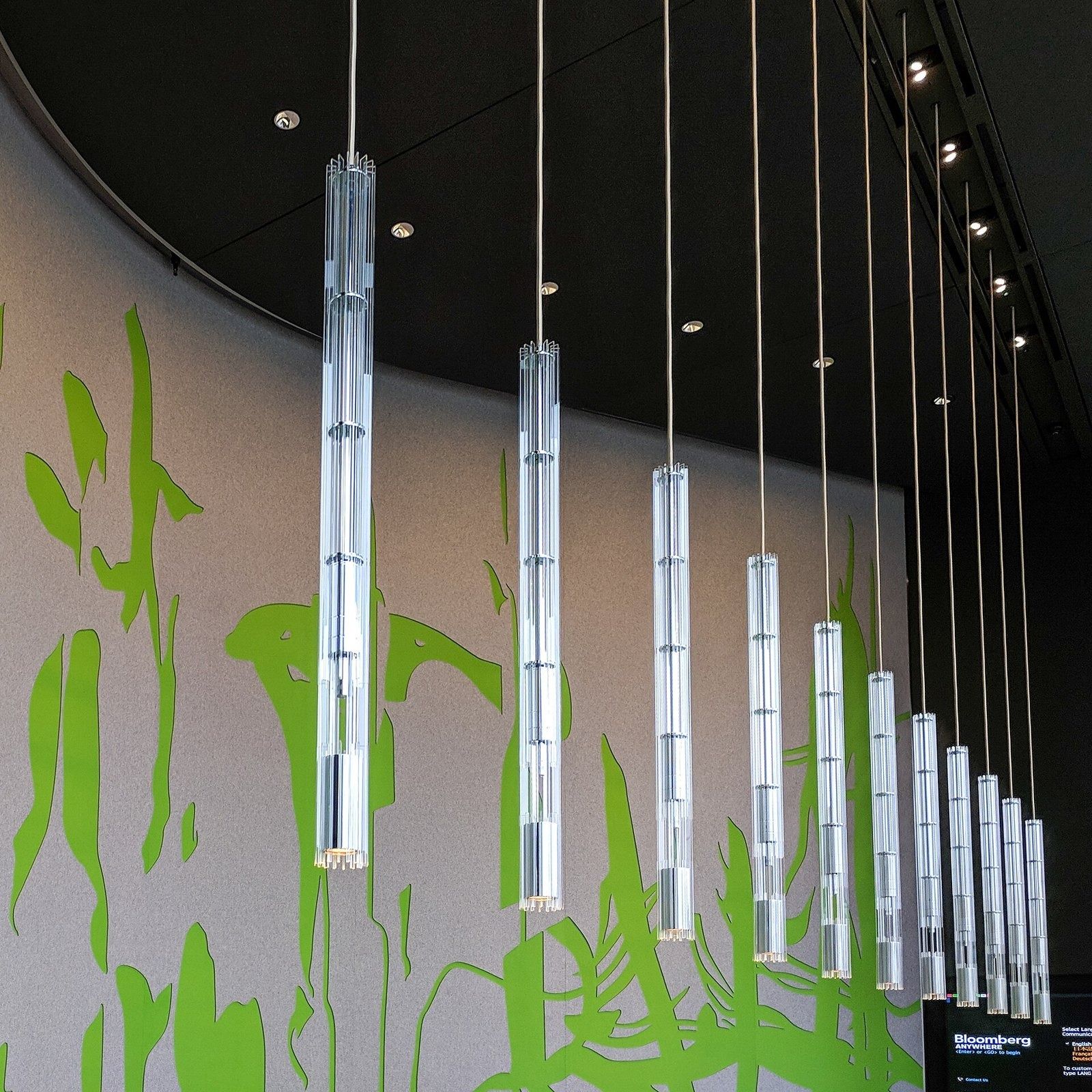 Bloomberg: Hanging light tubes in front of a green mural