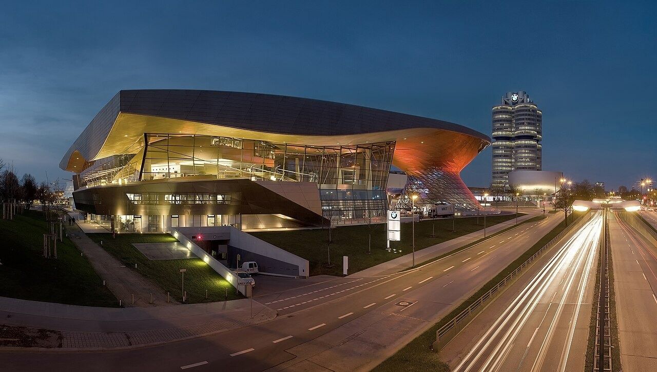 BMW Welt at night with the BMW tower behind