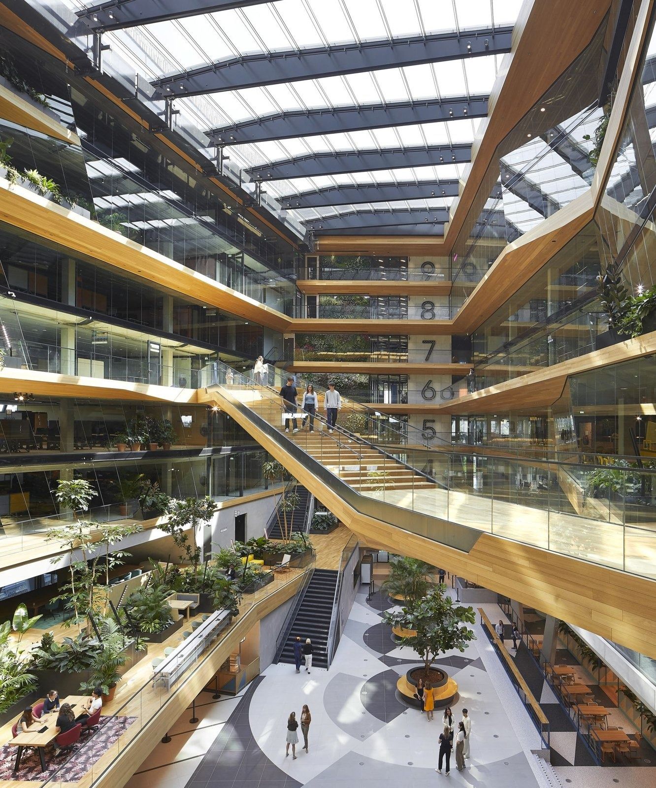 Booking Holdings: Tall atrium with timber balconies and a ground-floor café