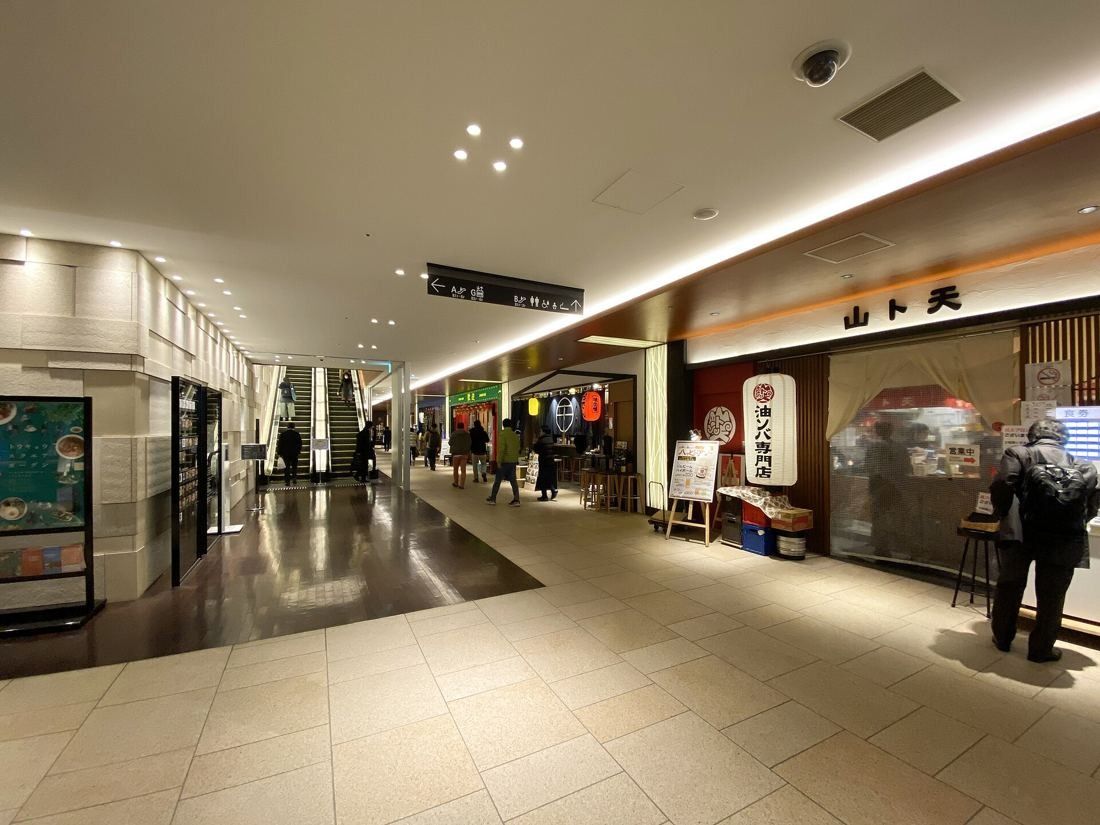 Bridgestone: A basement arcade of restaurants with escalators at the far end