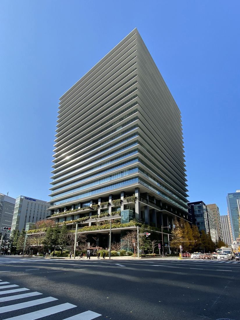 Bridgestone: The tower seen from across a wide street under a clear blue sky