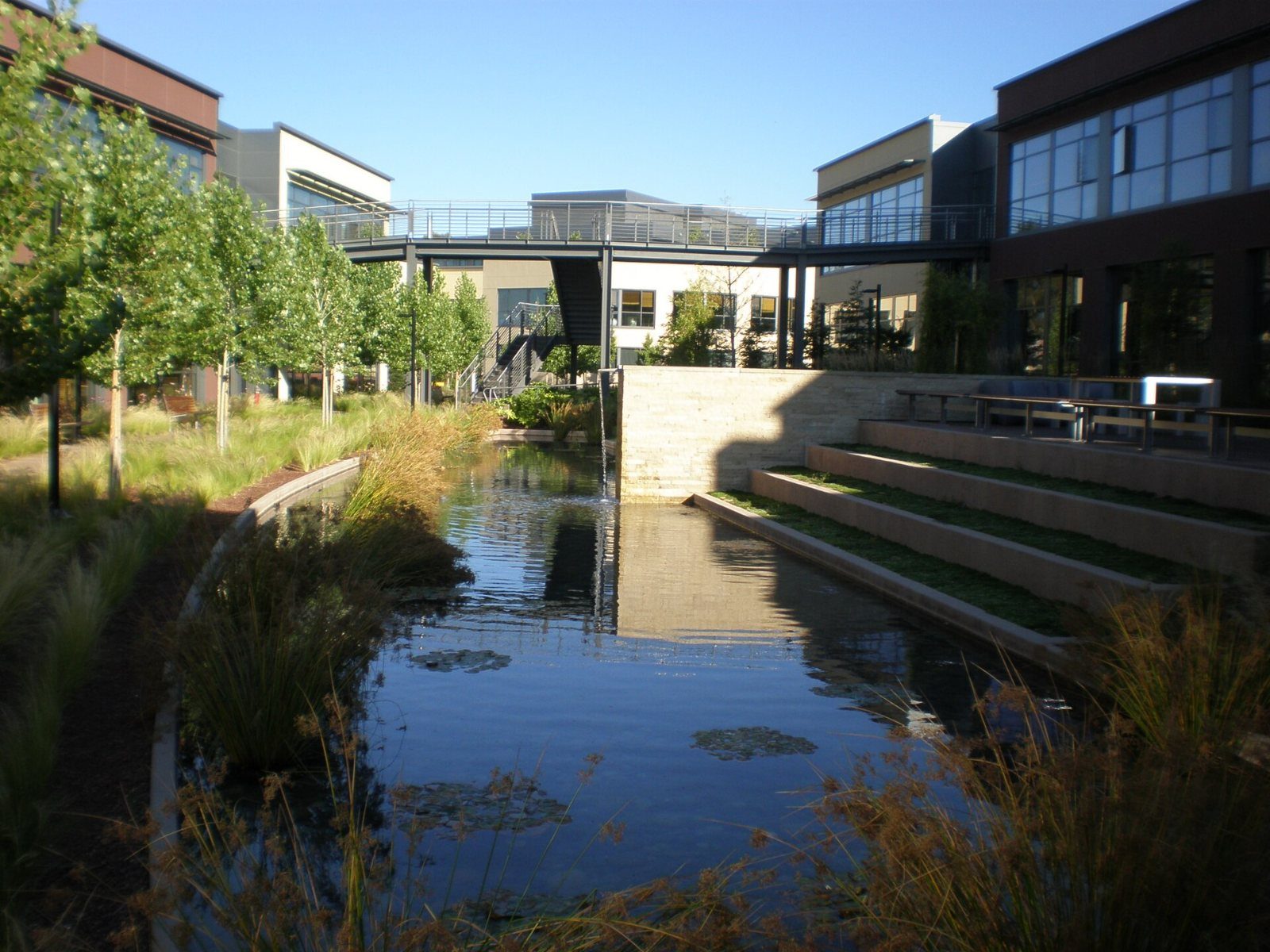 Pond with a small waterfall between buildings
