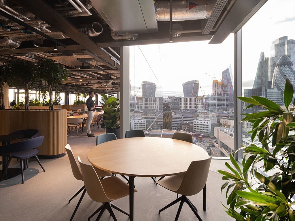 BT Group: Round table by a window with a view of the City towers
