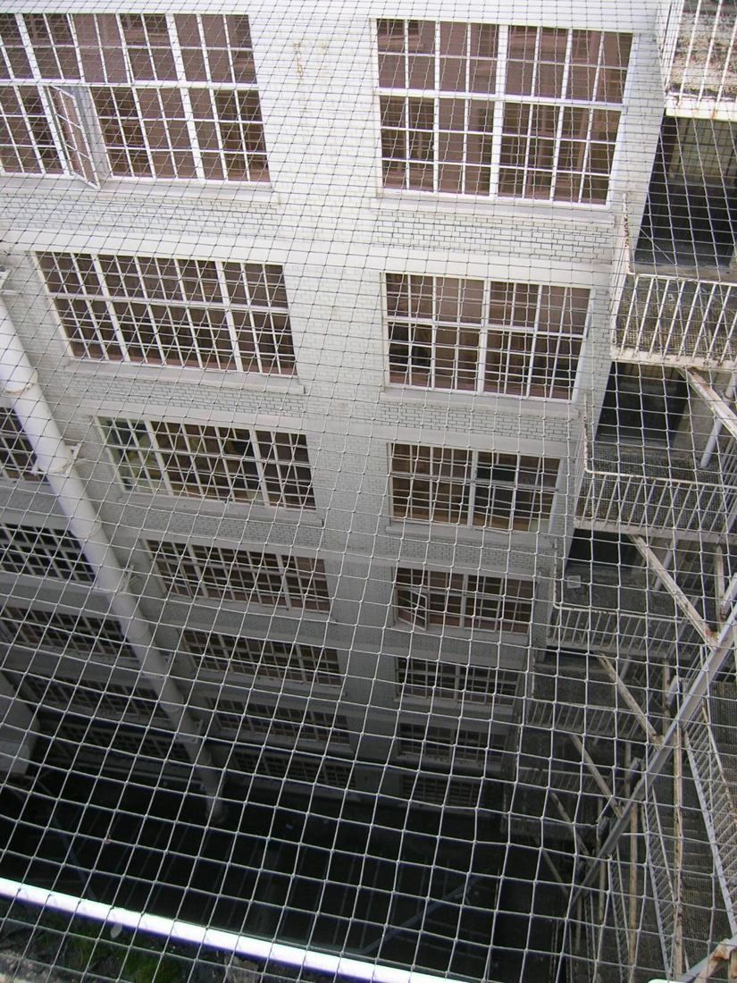 Burberry: Looking down a narrow lightwell lined with gridded windows over a mesh grille
