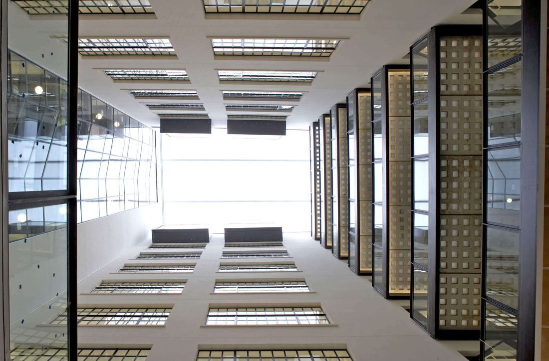 Burberry: View up a white full-height atrium to a glass roof, with black-framed bridges and glazed walls on one side