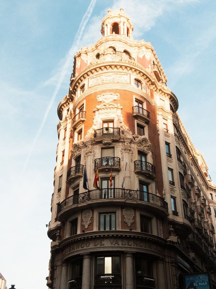 CaixaBank: The rounded corner lit by low sun against a pale sky
