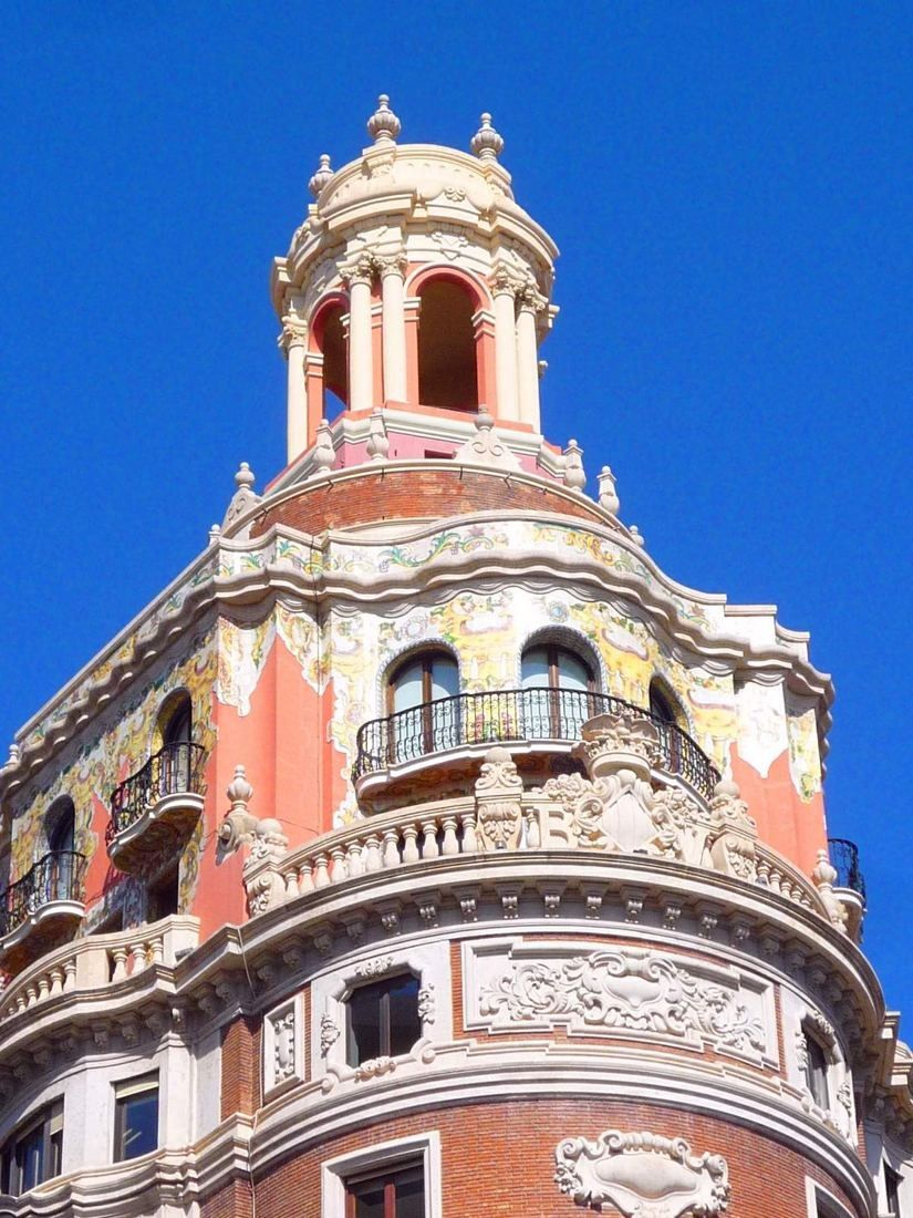 CaixaBank: Upper corner with domed lantern against a vivid blue sky