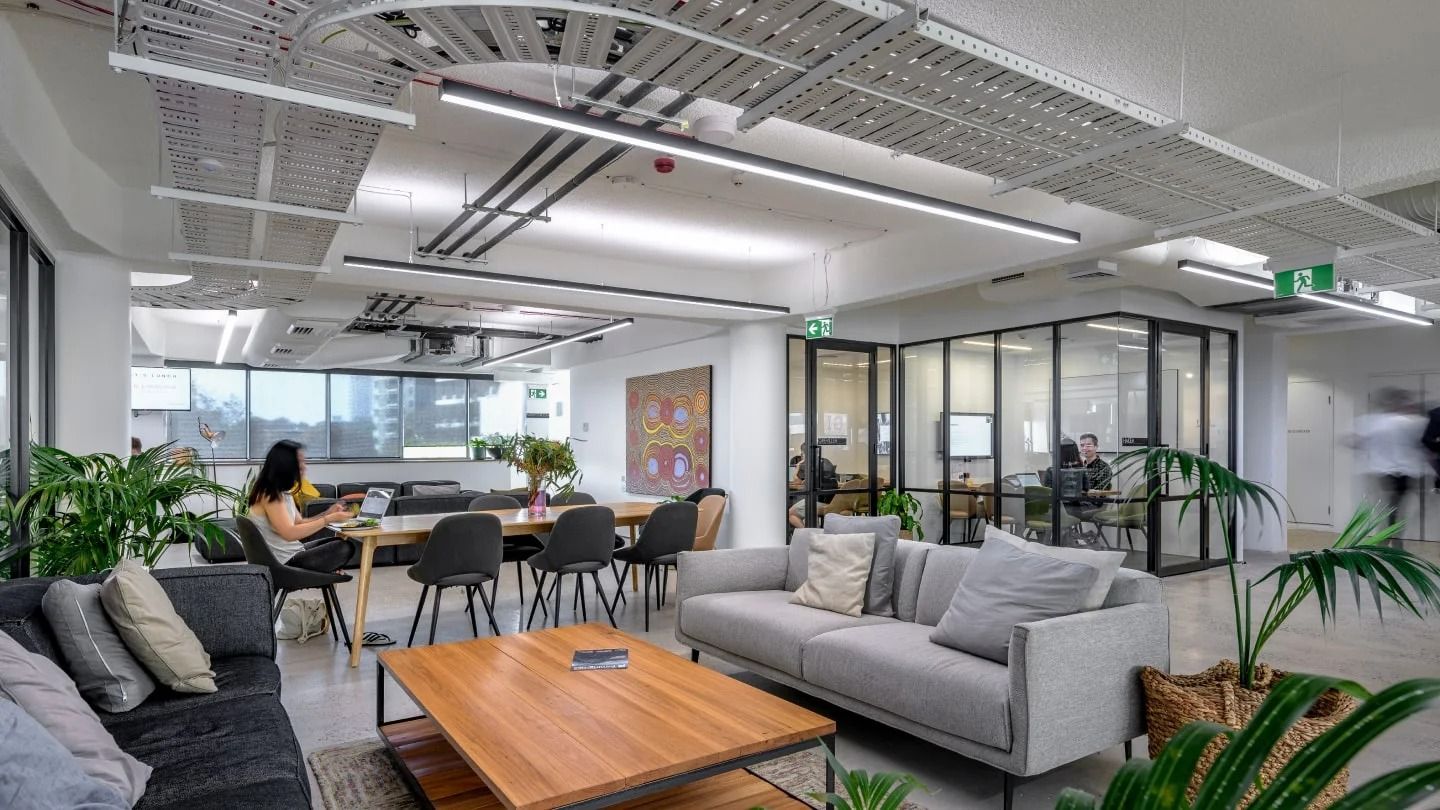 Canva: Lounge sofas in front of glass meeting rooms